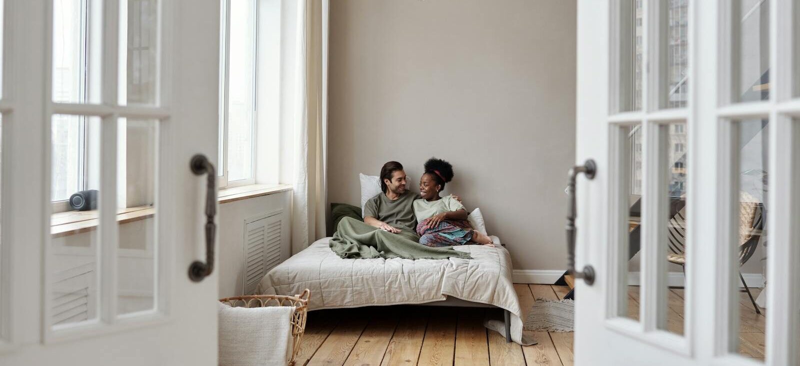 Couple Smiling in Bed