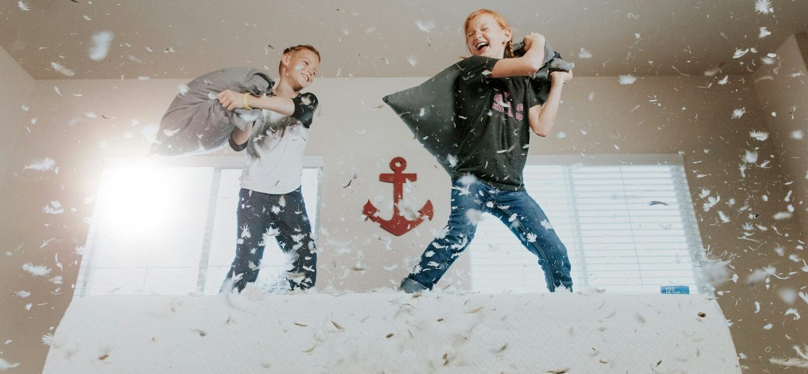 two toddler pillow fighting